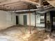 Unfinished basement offers space for storage or customization with exposed ductwork and painted cinder block walls at 311 N Nash St, Hillsborough, NC 27278