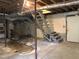 Spacious unfinished basement provides potential with stairs, a vintage stove, and utility connections at 311 N Nash St, Hillsborough, NC 27278