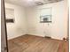 Bedroom with hardwood floors, two windows, and an AC unit at 311 N Nash St, Hillsborough, NC 27278