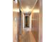 Long hallway featuring wood floors and wood paneled walls with multiple doors at 311 N Nash St, Hillsborough, NC 27278