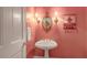 Elegant powder room with pedestal sink and decorative mirror at 3203 Cameron Dr, Henderson, NC 27536