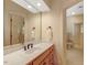 This spacious bathroom has a vanity with a sleek countertop, complemented by clean, bright lighting at 3203 Cameron Dr, Henderson, NC 27536