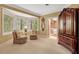Cozy bedroom sitting area with chairs and a view of the trees outside the window at 3203 Cameron Dr, Henderson, NC 27536