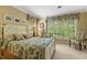 Comfortable bedroom features a bed with decorative pillows and large windows with patterned curtains at 3203 Cameron Dr, Henderson, NC 27536