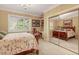 Inviting bedroom boasts natural light, a cozy bed, and a mirrored closet reflecting the room's ambiance at 3203 Cameron Dr, Henderson, NC 27536