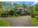 Sprawling home showcasing a large driveway and lush landscaping at 3203 Cameron Dr, Henderson, NC 27536
