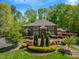 Stately brick home with mature trees, manicured lawn, and colorful landscaping at 3203 Cameron Dr, Henderson, NC 27536
