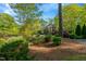 A beautiful brick home surrounded by lush greenery and mature trees at 3203 Cameron Dr, Henderson, NC 27536