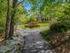 Beautiful home showcasing a circular driveway, manicured landscaping, and vibrant floral arrangements at 3203 Cameron Dr, Henderson, NC 27536