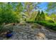 Landscaped garden featuring a stone patio and raised garden beds at 3203 Cameron Dr, Henderson, NC 27536