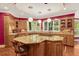 The kitchen boasts wood cabinets, granite countertops, a gas range island, and natural light from surrounding windows at 3203 Cameron Dr, Henderson, NC 27536