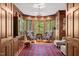 Elegant living room with wood paneling, bay window, and comfortable seating at 3203 Cameron Dr, Henderson, NC 27536