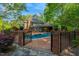 Private pool area surrounded by a brick fence and mature greenery at 3203 Cameron Dr, Henderson, NC 27536
