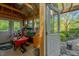 Well-lit shed with exposed wooden beams, and door to the landscaped backyard at 3203 Cameron Dr, Henderson, NC 27536