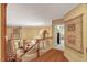 The staircase offers views of the living room, a decorative chandelier, and a wall tapestry at 3203 Cameron Dr, Henderson, NC 27536