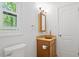This bathroom features a wood-style vanity and a window for natural light at 3605 Moonlight Dr, Chapel Hill, NC 27516