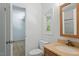 Bathroom with a granite vanity and a small window for natural light at 3605 Moonlight Dr, Chapel Hill, NC 27516