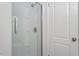 A glass shower door leads to a white tiled shower in this bright bathroom at 3605 Moonlight Dr, Chapel Hill, NC 27516