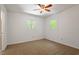 Bright bedroom with neutral carpet, ceiling fan, and views to the yard at 3605 Moonlight Dr, Chapel Hill, NC 27516