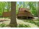 Exterior home view with long deck surrounded by mature trees at 3605 Moonlight Dr, Chapel Hill, NC 27516