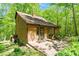 Charming home exterior featuring wood siding, brick patio, and lush green landscaping at 3605 Moonlight Dr, Chapel Hill, NC 27516