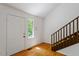 Entryway showcasing hardwood floors, staircase, and natural light through a nearby window at 3605 Moonlight Dr, Chapel Hill, NC 27516