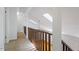 Bright hallway with skylights and wood railing offers views to lower level at 3605 Moonlight Dr, Chapel Hill, NC 27516