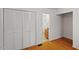 Hallway with beautiful hard wood floors leads to a bathroom with a wooden vanity at 3605 Moonlight Dr, Chapel Hill, NC 27516