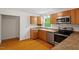 Well-maintained kitchen featuring stainless appliances, wood cabinets, and hardwood flooring at 3605 Moonlight Dr, Chapel Hill, NC 27516