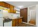 A modest kitchen area features dark cabinets, tile, and wood-look floors at 3605 Moonlight Dr, Chapel Hill, NC 27516