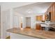 Well-lit kitchen featuring stainless appliances and granite countertops, open to living area at 3605 Moonlight Dr, Chapel Hill, NC 27516