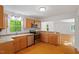 Bright kitchen boasts stainless steel appliances, wood cabinets and hardwood flooring at 3605 Moonlight Dr, Chapel Hill, NC 27516