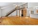 Open living room with wood floors, fireplace, and staircase leading to upper level at 3605 Moonlight Dr, Chapel Hill, NC 27516