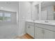 Spacious bathroom featuring double vanities, framed mirrors, and access to bedroom at 3705 Rosebush Dr, Zebulon, NC 27597