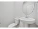 Clean and bright bathroom with a pedestal sink, toilet, and mirror at 3705 Rosebush Dr, Zebulon, NC 27597