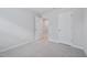 Neutral-toned bedroom with plush carpeting, gray walls, and two interior doors at 3705 Rosebush Dr, Zebulon, NC 27597