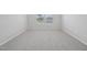 A bright bedroom featuring neutral carpeting, light gray walls, and two large windows for natural light at 3705 Rosebush Dr, Zebulon, NC 27597