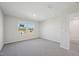 A bright bedroom featuring neutral paint, carpet, and view through the window at 3705 Rosebush Dr, Zebulon, NC 27597