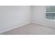 Bright bedroom with neutral carpeting, light gray walls, and a window providing ample natural light at 3705 Rosebush Dr, Zebulon, NC 27597