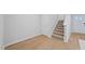 Bright entryway with wood-look floors, staircase, and white trim at 3705 Rosebush Dr, Zebulon, NC 27597
