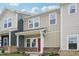 Attractive townhome with neutral siding, a covered porch, and well-manicured landscaping at 3705 Rosebush Dr, Zebulon, NC 27597