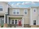 Inviting two-story townhome boasts a covered porch and classic architectural details at 3705 Rosebush Dr, Zebulon, NC 27597