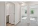 Hallway with multiple bedroom entryways and natural light at 3705 Rosebush Dr, Zebulon, NC 27597