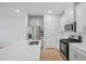 Modern kitchen with stainless steel appliances, white cabinets, and an island with a sink at 3705 Rosebush Dr, Zebulon, NC 27597