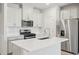 Modern kitchen with white cabinets, stainless steel appliances, and island at 3705 Rosebush Dr, Zebulon, NC 27597