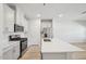 Kitchen featuring white cabinets, stainless steel appliances, quartz counters and wood floors at 3705 Rosebush Dr, Zebulon, NC 27597