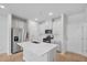 Modern kitchen with stainless steel appliances, white cabinets, and an island with a sink at 3705 Rosebush Dr, Zebulon, NC 27597