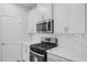 Close up of modern kitchen with stainless steel appliances and white cabinets at 3705 Rosebush Dr, Zebulon, NC 27597