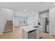Modern kitchen with stainless steel appliances, white cabinets, and a center island at 3705 Rosebush Dr, Zebulon, NC 27597