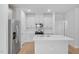 Modern kitchen with stainless steel appliances, white cabinets, and an island with a sink at 3705 Rosebush Dr, Zebulon, NC 27597